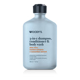 A bottle of Woody's 3-in-1 shampoo, conditioner, and body wash with a light blue-gray body, black cap, and black text on a white background.