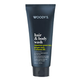 Woody's Hair & Body Wash in a dark navy blue squeeze tube with white and yellow text, on a plain white background.