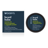 Woody's Beard Balm coconut oil, natural beeswax + vegetable protein, shown with its navy blue retail box and round black jar on a white background.