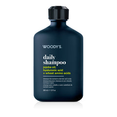 Woody's Daily Shampoo in a dark navy blue bottle with a black cap, on a white background with a soft reflection.
