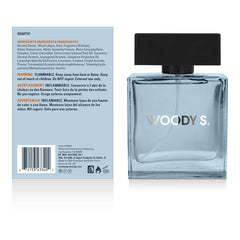 Woody's Eau de Toilette bottle shown next to its back packaging label. The bottle is a light blue translucent glass with a black cap and 'WOODY'S' printed in silver.
