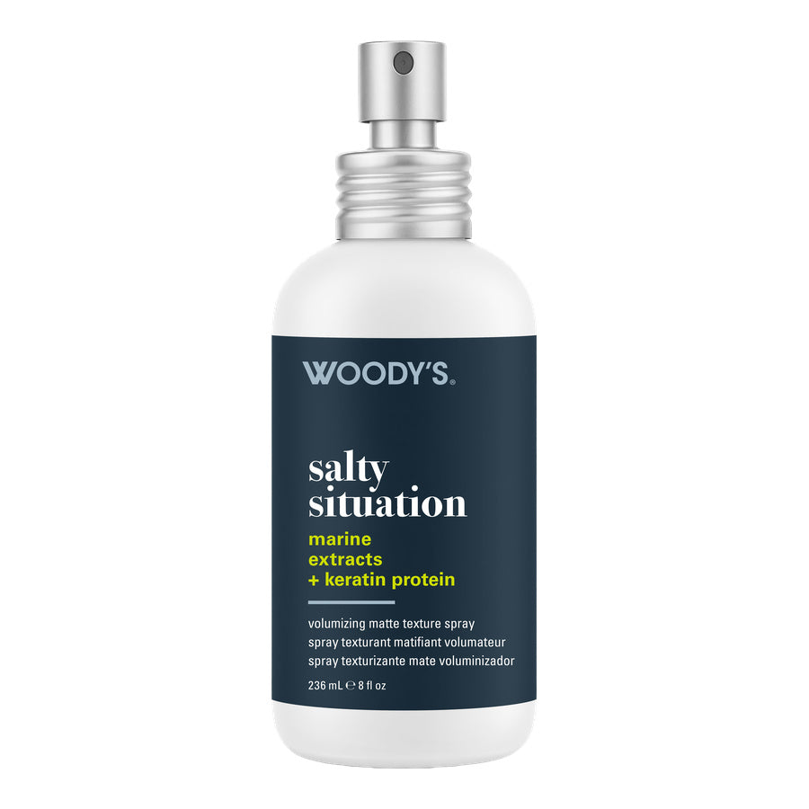 Woody's Salty Situation Marine Extracts + Keratin Protein matte texture spray in a 238 mL white bottle with a dark navy label and silver spray nozzle, shown on a plain white background.