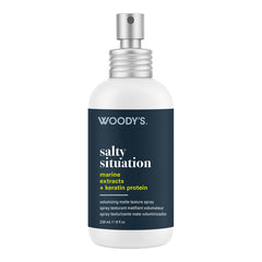 Woody's Salty Situation Marine Extracts + Keratin Protein matte texture spray in a 238 mL white bottle with a dark navy label and silver spray nozzle, shown on a plain white background.