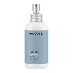 Woody's Marte body spray in a 226 mL white bottle with a matte slate blue label and a silver spray nozzle, shown on a plain white background.