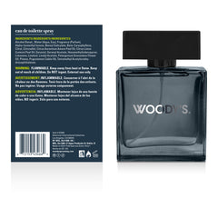 Woody's Eau de Toilette Spray bottle shown from the front and back. The bottle is a dark smoky gray glass with a black cap, and the back panel is dark blue with product details and a barcode.
