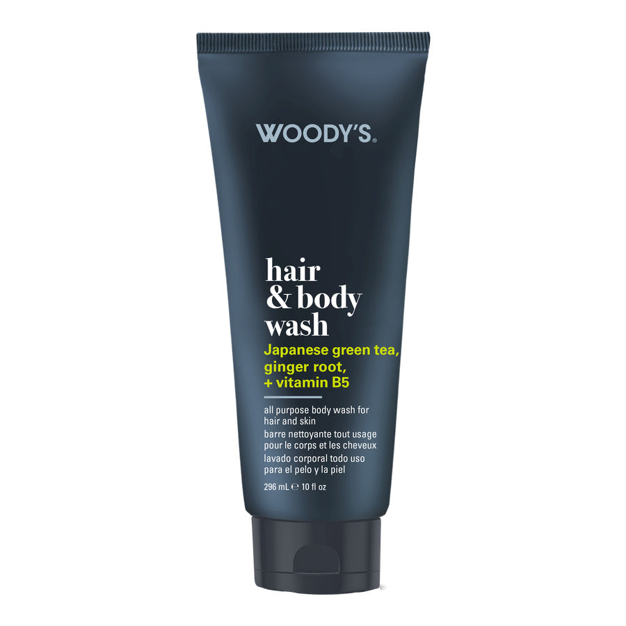 Woody's Hair & Body Wash in a dark navy blue squeeze tube with white and yellow text, on a plain white background.