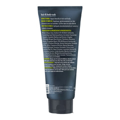A single tube of hair and body wash shown from the back on a plain white background. The tube is dark navy blue with white and yellow text detailing the ingredients and directions.