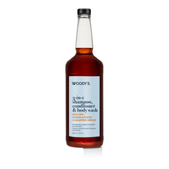 A bottle of Woody's 3-in-1 Shampoo, Conditioner, and Body Wash with a white label and amber liquid, set against a plain white background.