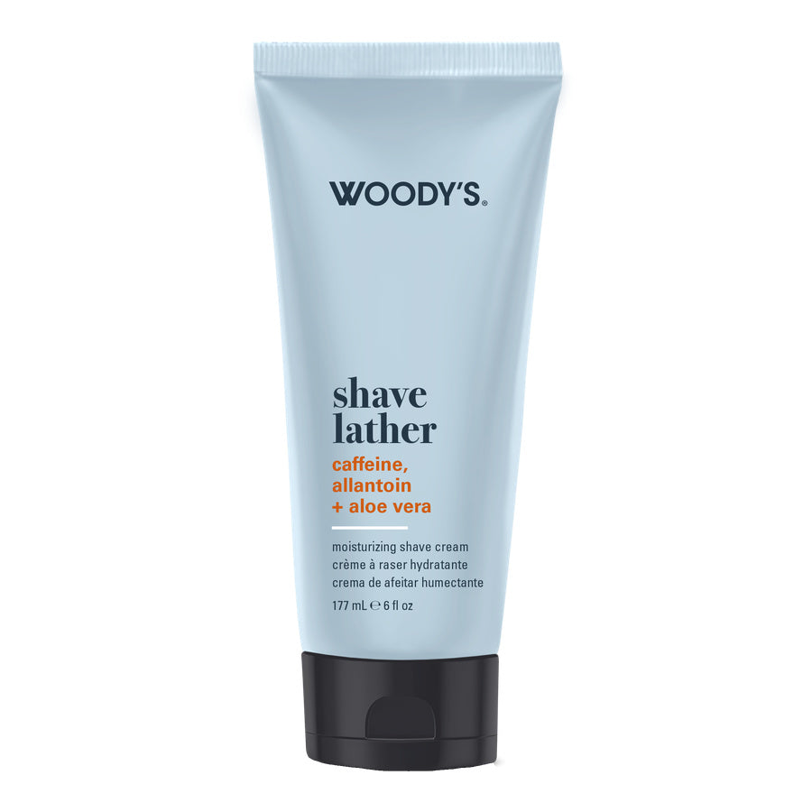 Woody's Shave Lather moisturizing shave cream in a light blue squeeze tube with a black cap, shown on a plain white background.