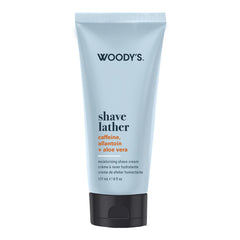 Woody's Shave Lather moisturizing shave cream in a light blue squeeze tube with a black cap, shown on a plain white background.