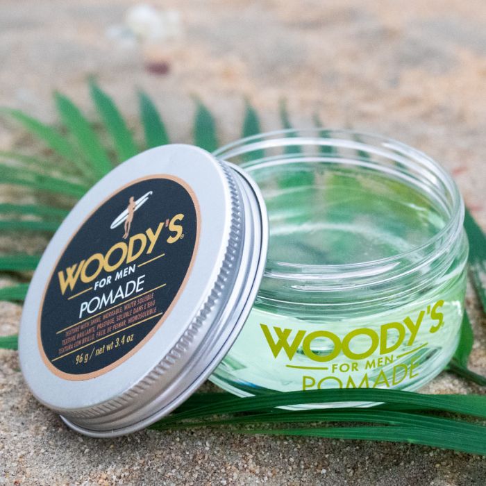 Woody's Pomade Open Jar showcasing a clear green pomade with a smooth texture, ensuring easy application and reworkable hold.