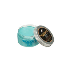 Woody’s Clay for Men Flexible Hold Hair Clay in an open tin with lid shapes and defines hair with a pliable, matte finish.