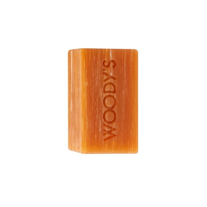 Woody's For Men Hair & Body Shampoo Bar Unwrapped revealing a translucent amber soap bar with moisturizing ingredients.