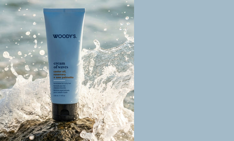 Woody’s cream of waves tube container with an ocean wave crashing in the background.
