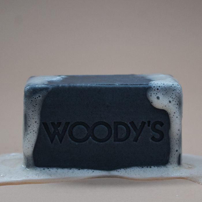 Woody's for Men Activated Charcoal Bar Soap (Lathered) foamy charcoal bar providing deep-cleansing action.